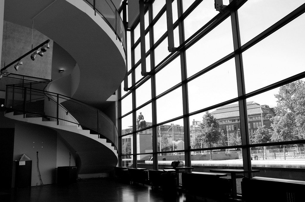 Black and white inside building looking out large glass window